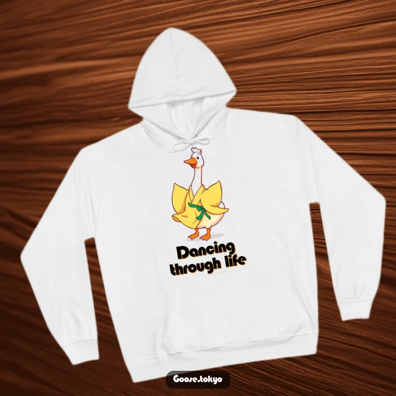 Funny goose hoodie, a happy goose in a flowing yellow kimono joyfully twirling, perfect for cozy days and cheerful vibes.