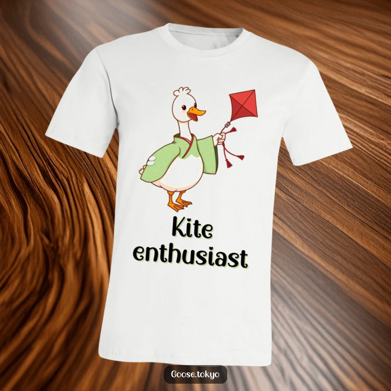 Funny T-shirt with a charming goose in a green patterned kimono twirling a decorative kite, embodying playful and lighthearted fun.