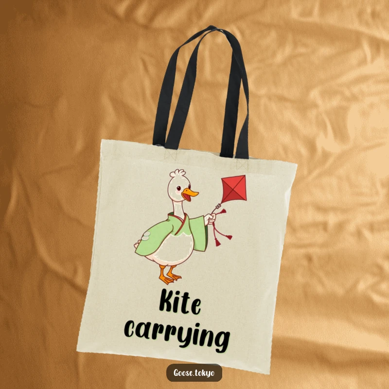 Funny tote bag with a charming goose in a green patterned kimono twirling a kite, perfect for carrying essentials with humor.